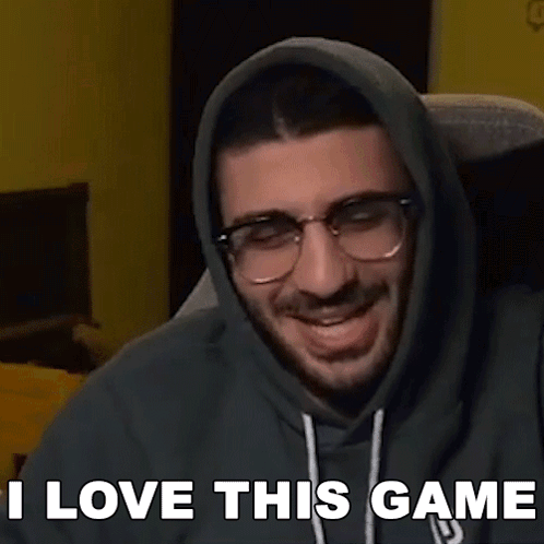 A Man Wearing Glasses And A Hoodie Says I Love This Game . GIF