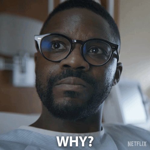 A Man Wearing Glasses And A Hospital Gown Is Asking Why GIF