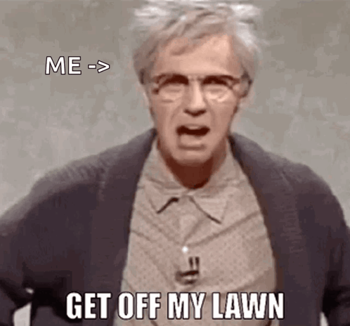A Man Wearing Glasses And A Jacket Is Yelling At The Camera And Says `` Get Off My Lawn '' . GIF