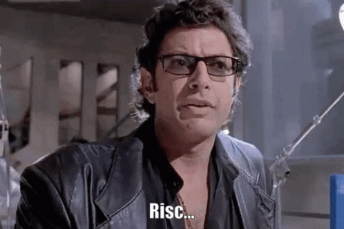 A Man Wearing Glasses And A Leather Jacket Is Making A Funny Face And Says Risc . GIF