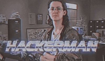 A Man Wearing Glasses And A Leather Jacket Is Standing In Front Of A Sign That Says Hackerman GIF