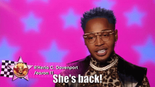A Man Wearing Glasses And A Leopard Print Shirt Says She 'S Back GIF