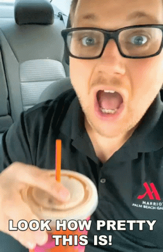 A Man Wearing Glasses And A Marriott Palm Beach Shirt Is Holding A Drink GIF