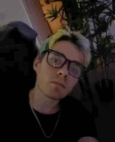 A Man Wearing Glasses And A Necklace Has The Words I Have A Bomb Written On His Face GIF