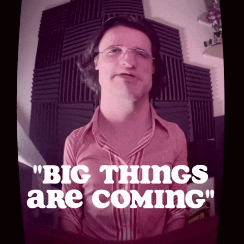 A Man Wearing Glasses And A Pink Shirt Says Big Things Are Coming GIF