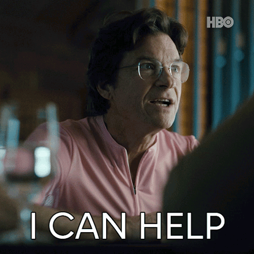 A Man Wearing Glasses And A Pink Shirt Says " I Can Help " GIF