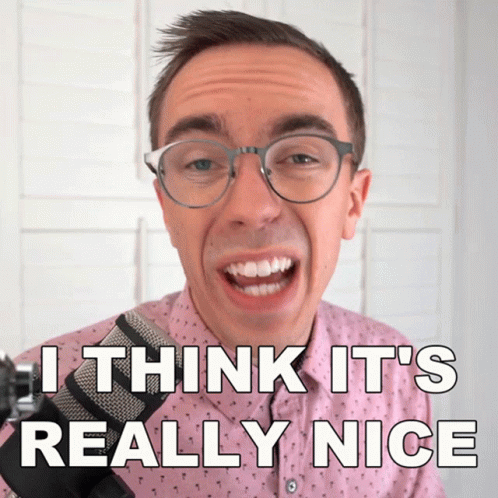 A Man Wearing Glasses And A Pink Shirt Says " I Think It 'S Really Nice " In Front Of A Microphone GIF