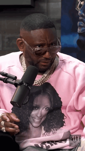 A Man Wearing Glasses And A Pink Sweatshirt With A Picture Of A Woman On It GIF