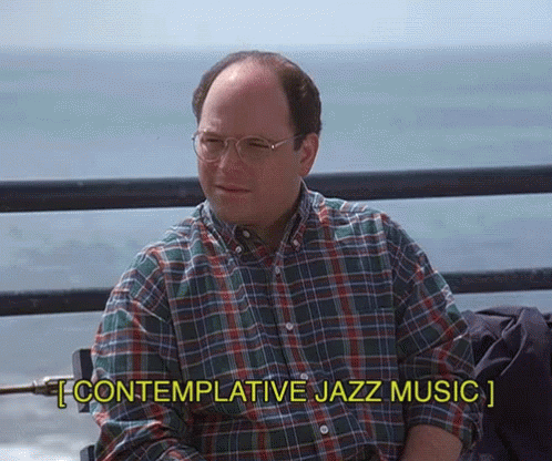 A Man Wearing Glasses And A Plaid Shirt Is Sitting On A Pier And Says Contemplative Jazz Music GIF