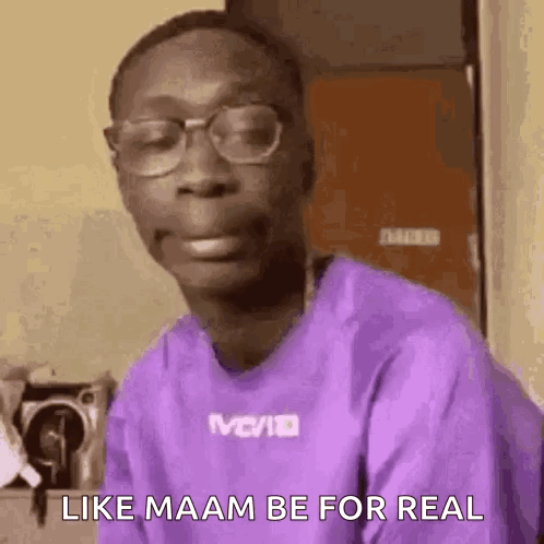 A Man Wearing Glasses And A Purple Shirt Is Making A Face . GIF