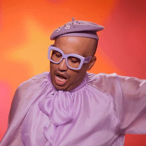 A Man Wearing Glasses And A Purple Shirt With The Word Swish Written On It GIF
