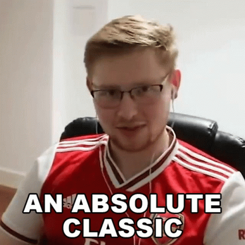 A Man Wearing Glasses And A Red And White Jersey Says An Absolute Classic GIF