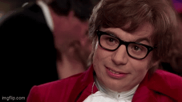 A Man Wearing Glasses And A Red Jacket Is Asking Come Again ? GIF