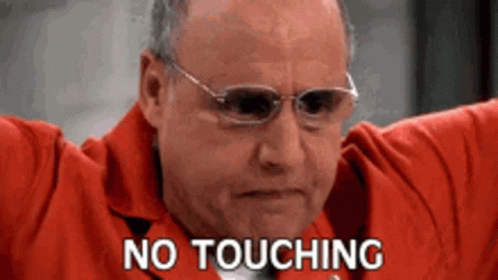 A Man Wearing Glasses And A Red Jacket Is Holding His Arms Out And Says `` No Touching '' . GIF