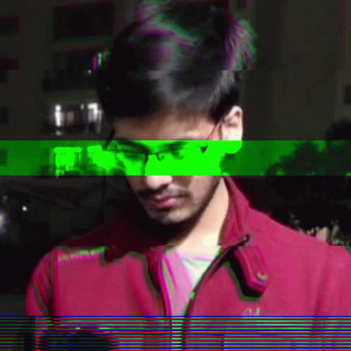 A Man Wearing Glasses And A Red Jacket With The Word Abercrombie On The Front GIF