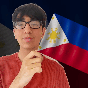 A Man Wearing Glasses And A Red Shirt Stands In Front Of A Flag GIF