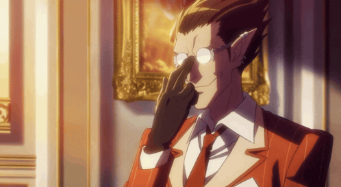 A Man Wearing Glasses And A Red Suit Has His Hand To His Nose GIF