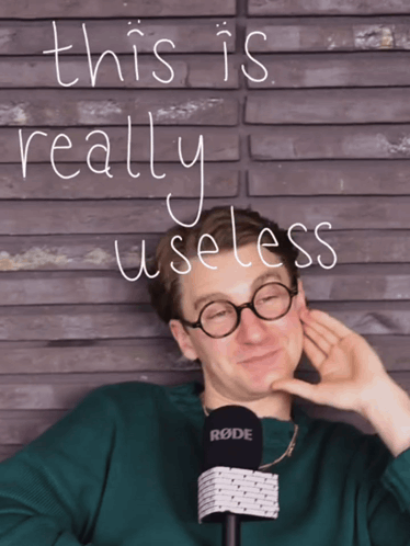 A Man Wearing Glasses And A Rode Microphone With The Words " This Is Really Useless " Above Him GIF