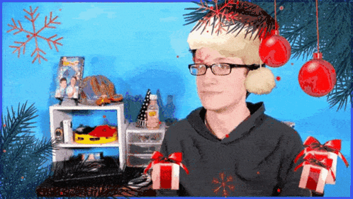 A Man Wearing Glasses And A Santa Hat Stands In Front Of A Christmas Tree GIF