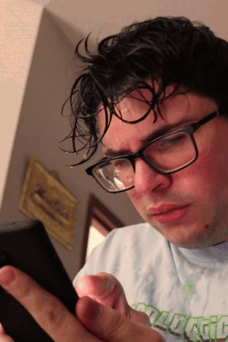 A Man Wearing Glasses And A Shirt That Says " Ecological " GIF