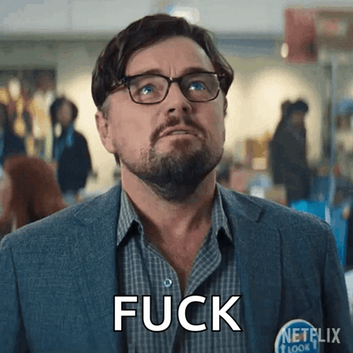 a man wearing glasses and a shirt that says fuck