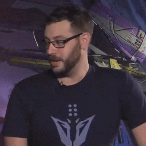 A Man Wearing Glasses And A Shirt That Says " No Raid " GIF