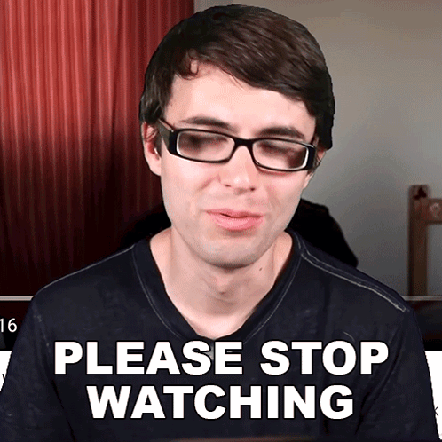 a man wearing glasses and a shirt that says please stop watching
