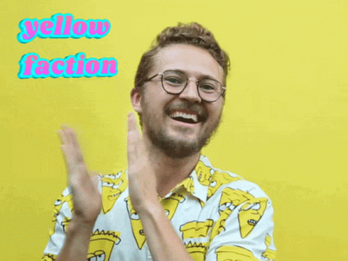A Man Wearing Glasses And A Shirt That Says Yellow Faction Is Clapping GIF