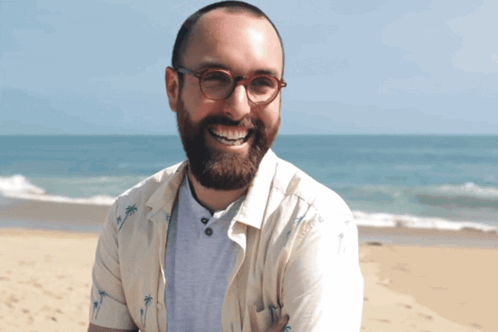 Man In Glasses Smiling On Beach With Palm Tree Shirt GIF