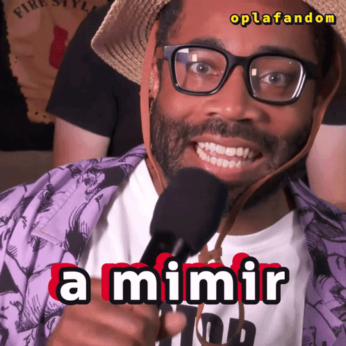A Man Wearing Glasses And A Straw Hat Is Holding A Microphone And Says A Mimir GIF