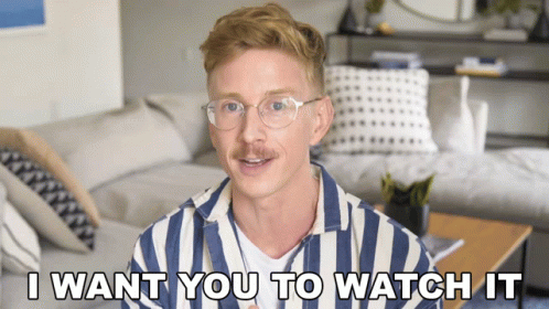 A Man Wearing Glasses And A Striped Shirt Says I Want You To Watch It GIF