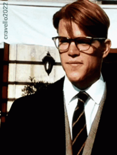 A Man Wearing Glasses And A Striped Tie Is Standing In Front Of A Sign That Says Cravello202022 GIF