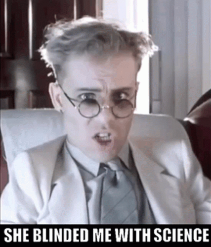 A Man Wearing Glasses And A Suit Has The Words She Blinded Me With Science Below Him GIF