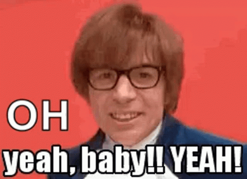 A Man Wearing Glasses And A Suit Is Smiling And Says `` Oh Yeah , Baby ! Yeah ! '' GIF