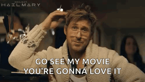 A Man Wearing Glasses And A Sweater Is Sitting At A Table And Talking To Someone . GIF