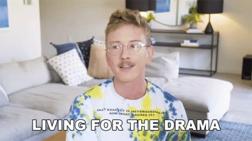 A Man Wearing Glasses And A Tie Dye Shirt Is Talking About Living For The Drama GIF