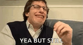 Man In Glasses And Vest Making Funny Face GIF