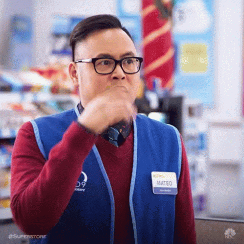 A Man Wearing Glasses And A Vest Is Making A Funny Face . GIF