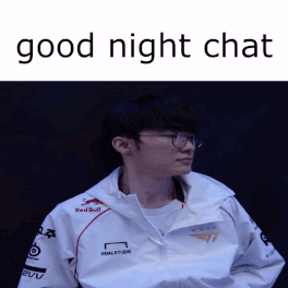 A Man Wearing Glasses And A White Jacket With Red Bull Written On It GIF