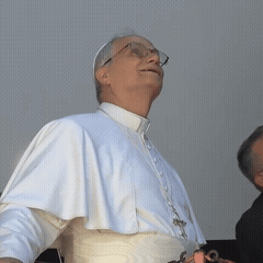 A Man Wearing Glasses And A White Robe Looks Up At The Sky GIF
