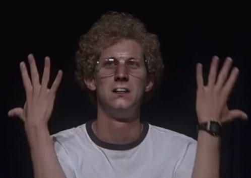 A Man Wearing Glasses And A White Shirt Has His Hands Up GIF
