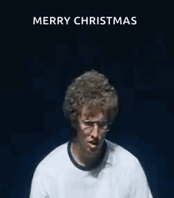 A Man Wearing Glasses And A White Shirt Is Making A Funny Face With His Hands In The Air . GIF
