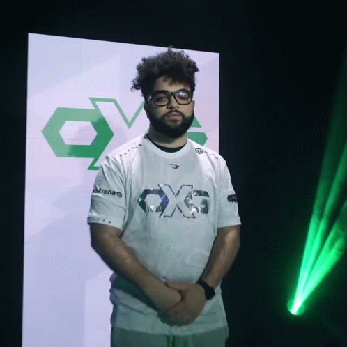 A Man Wearing Glasses And A White Shirt That Says Ox6 GIF