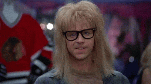 A Man Wearing Glasses And A Wig Is Smiling . GIF