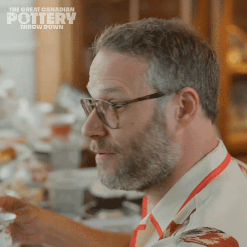 A Man Wearing Glasses And An Apron With The Words The Great Canadian Pottery Throw Down On The Bottom GIF