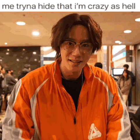 A Man Wearing Glasses And An Orange Jacket That Says Palace On It GIF