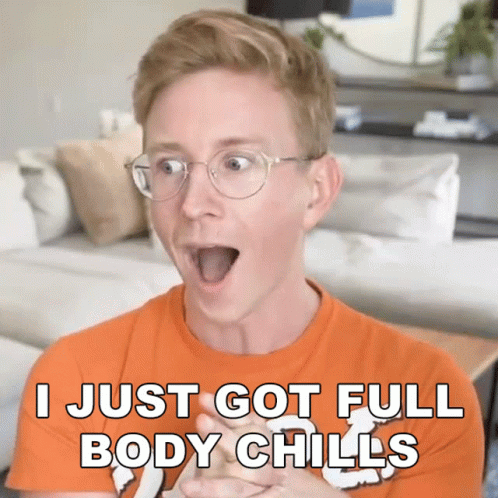 A Man Wearing Glasses And An Orange Shirt Says I Just Got Full Body Chills GIF