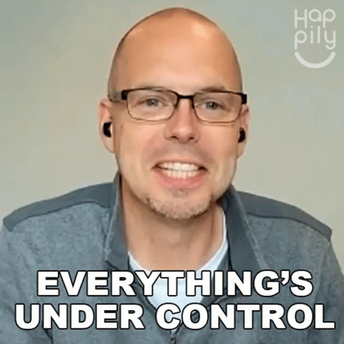 A Man Wearing Glasses And Ear Buds Is Smiling And Says Everything 'S Under Control GIF
