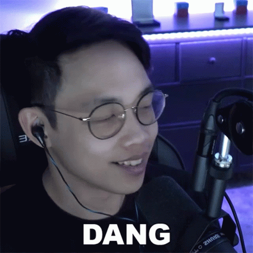 A Man Wearing Glasses And Ear Buds Says Dang GIF