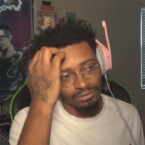 A Man Wearing Glasses And Headphones Has A Tattoo On His Arm GIF